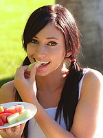 Catie Minx enjoying some fruit getting naked by the pool